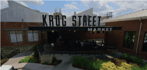 Krog Street Market entrance with brick facade, outdoor seating, and a large sign reading KROG STREET MARKET