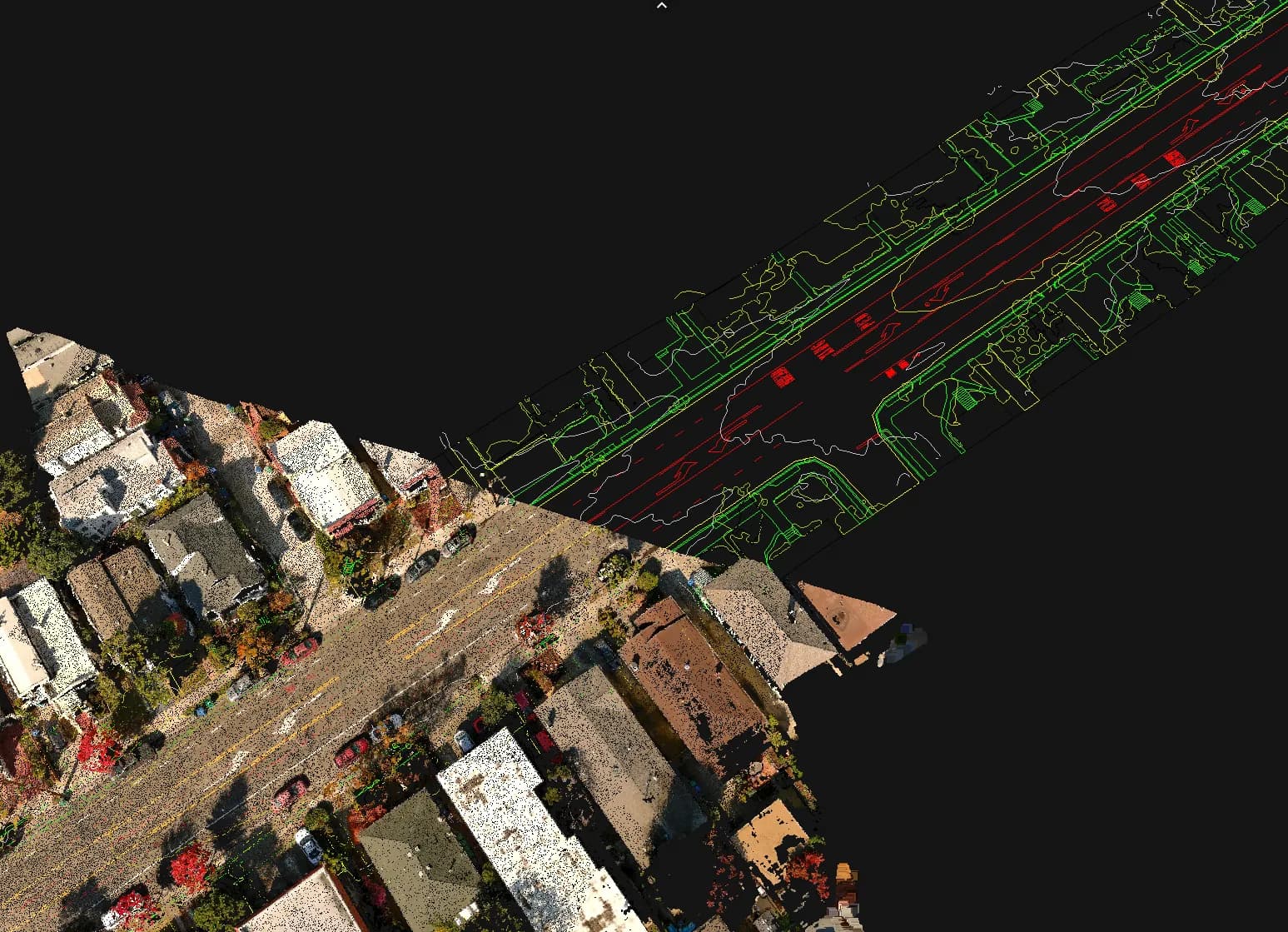 Aerial street scene with buildings and cars bottom left, and red road-network overlay along the diagonal