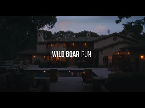 Evening exterior of a villa with a lit patio and pool, trees around; overlay text reads Wild Boar Run