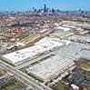 Aerial view of a city with dense flat rooftops and industrial warehouses
