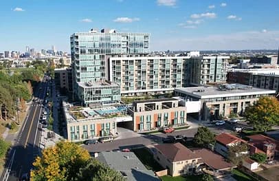 Bird's-eye view of a modern urban building complex with glass towers and surrounding streets