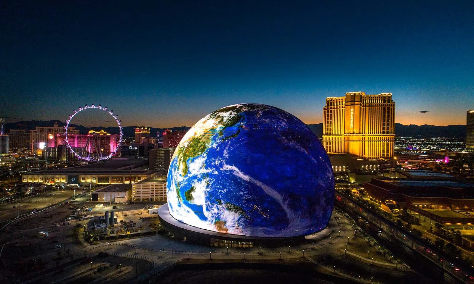 Logo for Drone Las Vegas featuring a large Earth globe against a Las Vegas skyline at dusk