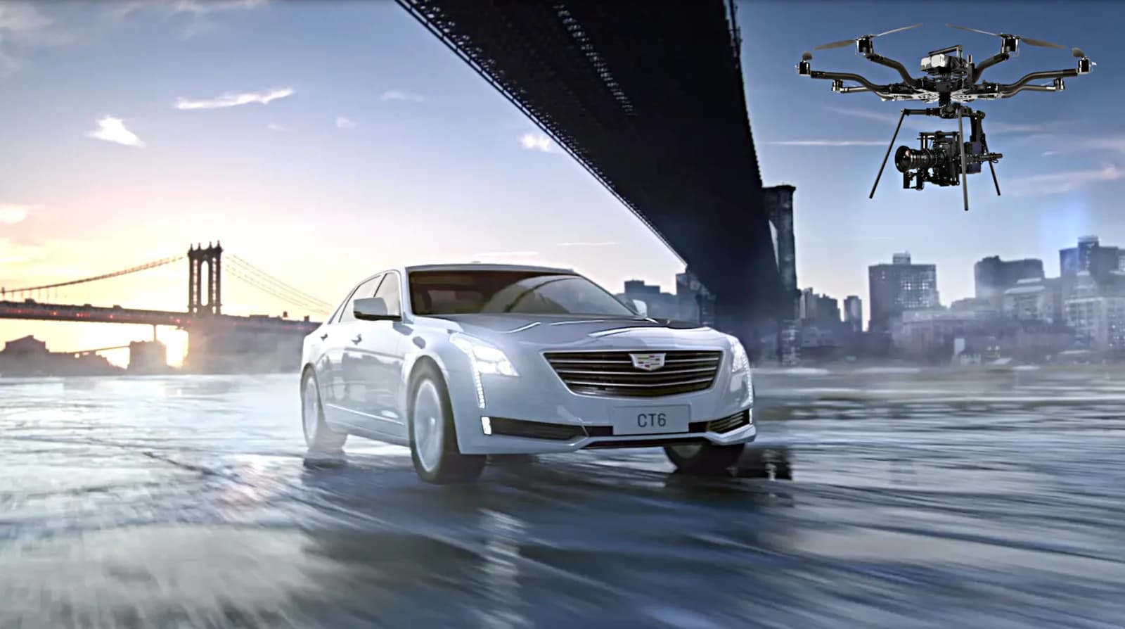 White car on a wet surface with a drone hovering over a city skyline and bridge