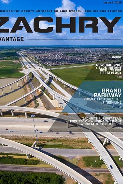 Aerial view of a highway interchange with multiple overpasses and a blue sky; magazine cover with ZACHRY