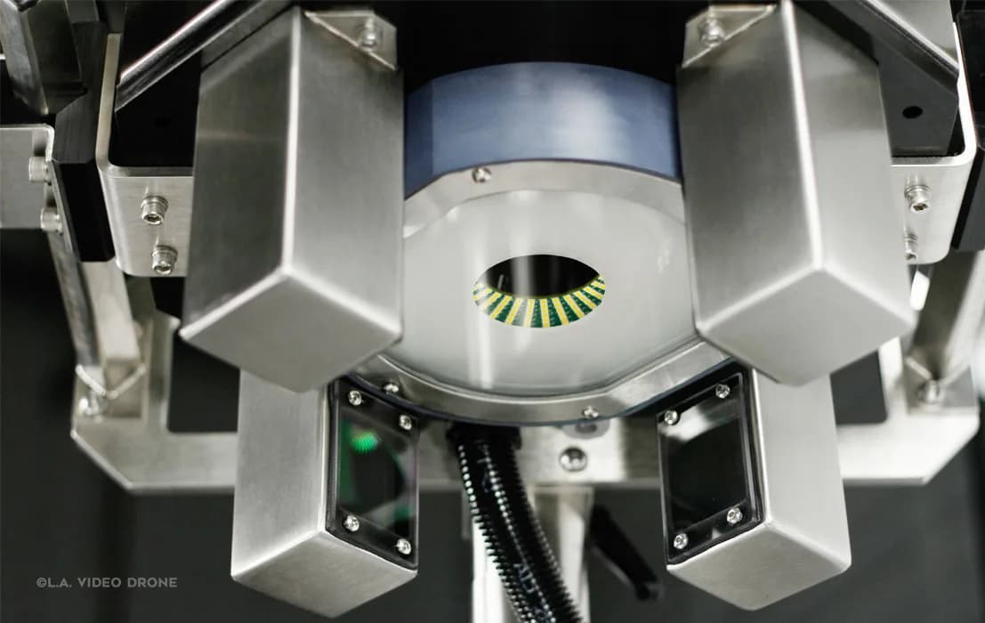 Close-up of stainless steel machinery with a central circular opening and a green-yellow segmented ring