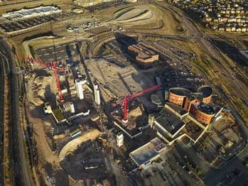 Aerial view of a construction site with cranes and partially built buildings