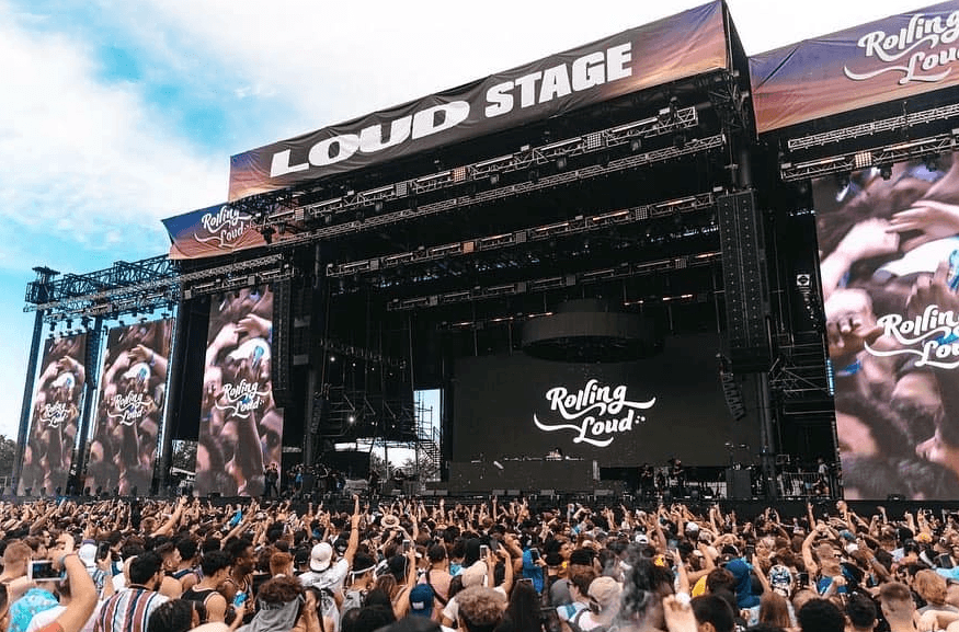 Large outdoor concert stage with a Loud Stage banner and Rolling Loud branding on screens