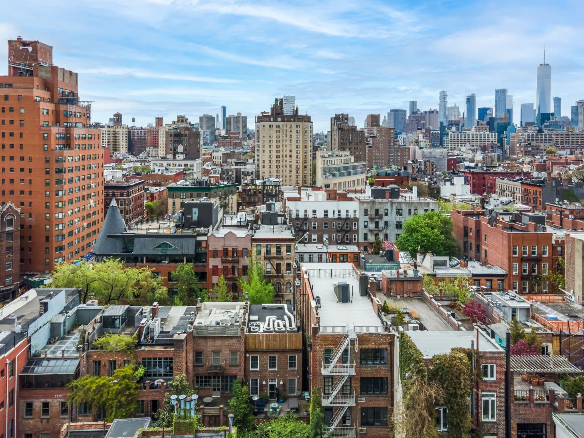 EmpireOptix portfolio photo of a city skyline with red brick buildings in the foreground and blue sky