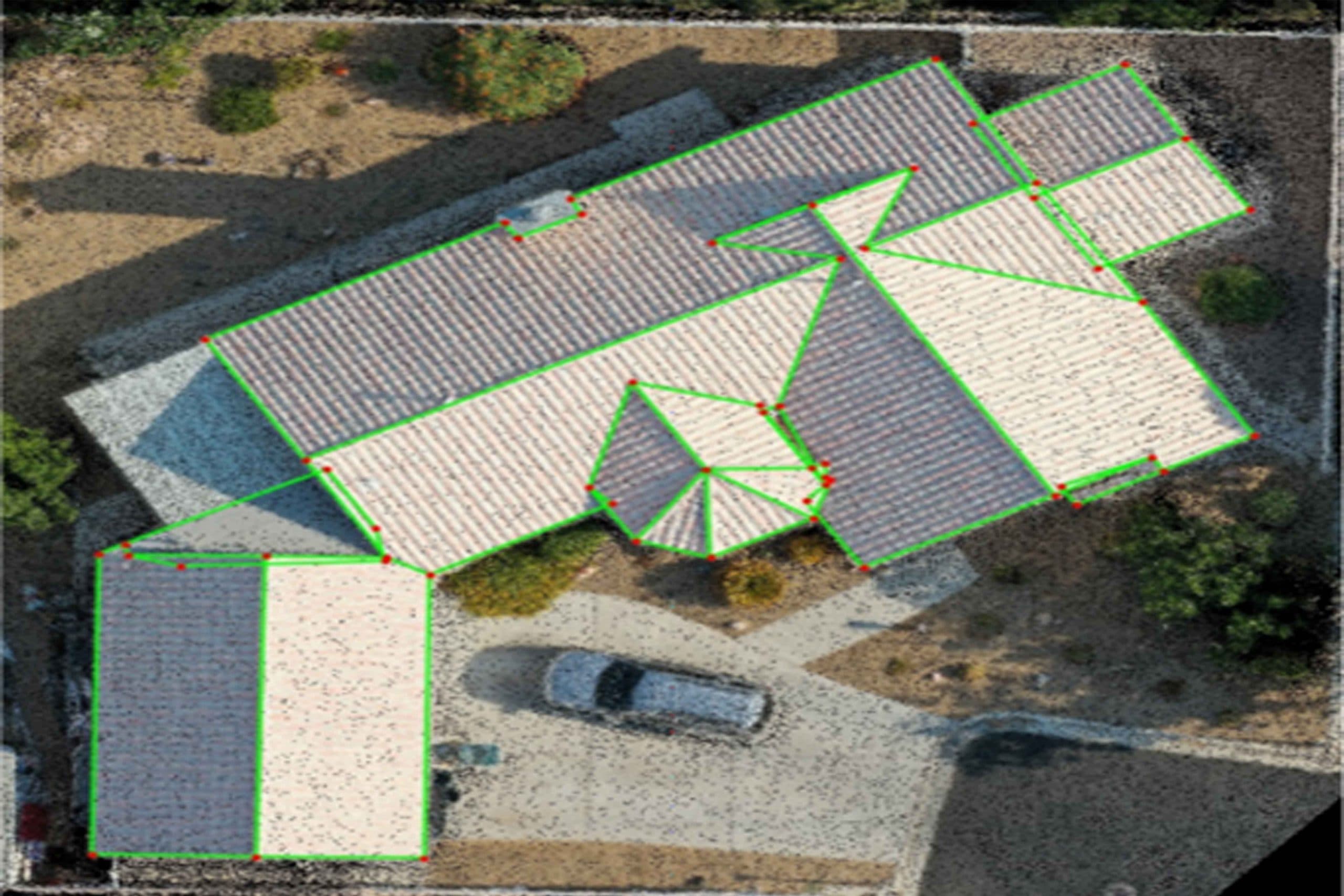 Aerial view of rooftops with green boundary polygons and red points