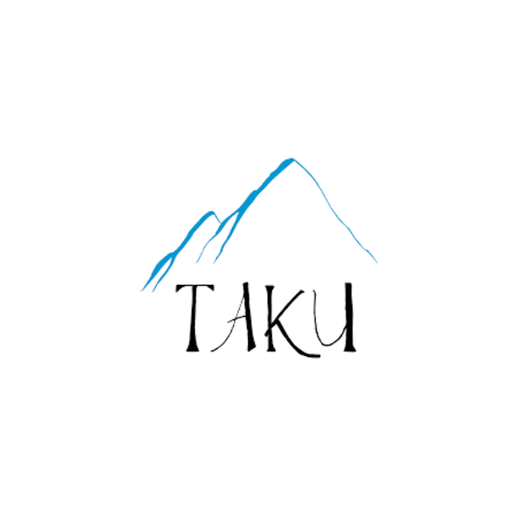 Logo for Taku Homes with a blue mountain outline above the word TAKU